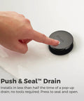 Finger pressing push and seal drain of Capistrano Matte Black 4-In Centerset 3-Hole Bathroom Sink Faucet With Dual Handles.