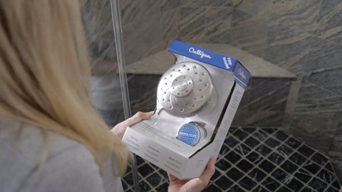Person holding Wall Mounted Filtered Shower Head With Anti Clog Rubber Nozzles, Five Spray Settings, Low Flow 1.2 GPM EPA Water Sense Certified in packaging.