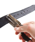 One Quarter Inch Hole Punch Handheld With Soft Grip Ergonomic Handle for DIY Crafts Scrapbooking punching holes in a black belt.