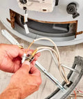 24-inch replacement thermocouple for gas furnaces; close-up of hands connecting beige wires to a metal probe