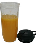 24oz cup filled with orange juice next to a black to-go lid, part of Two Pack 24oz Cups With To Go Lids And Easy Twist Extractor Blade.