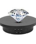 Hype Your Product With This Sick 3-In-1 Electric Rotating Display Stand That Spins Smooth 360 Degrees So You Can Score Crisp Photos And Viral Tiktok Videos Anytime You Need, showcasing a crystal diamond on a black rotating base.