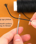 Hands threading needle with Waxed Thread Upholstery Kit With 32 Yards Of Durable Waxed Thread And 7 Hand Sewing Needles for DIY projects.