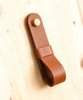 Close-up of a brown leather curtain rod holder from the Six Piece Robust Leather Curtain Rod Holders With Universal Wall Mount Kits.