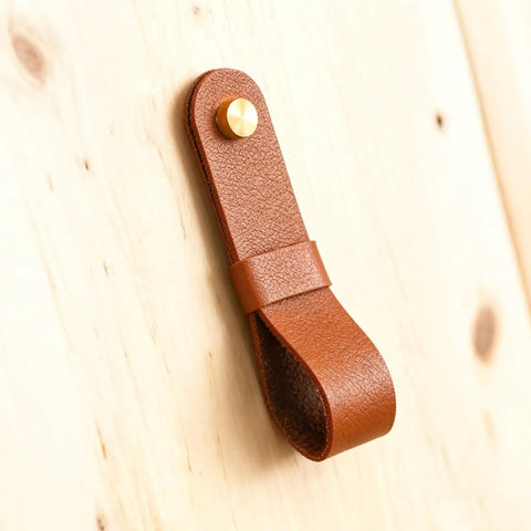 Close-up of a brown leather curtain rod holder from the Six Piece Robust Leather Curtain Rod Holders With Universal Wall Mount Kits.