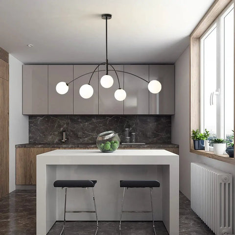 Matt Black Sputnik Chandelier Five Light Pendant hanging over modern kitchen island with stools, grey cabinets, and green decor.