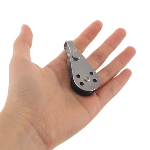 Beefy Stainless Steel Rope Pulley Block Set 4 Pack Heavy Duty Swivel Pulley shown in hand for size comparison