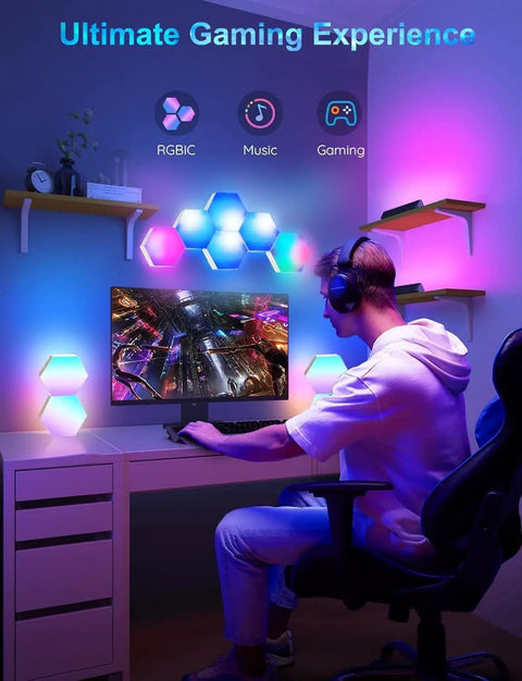 Lit RGB Hexagon LED Panel Lights for Wall with Smart App Control in a gaming room setup, seven panels illuminating a desk area