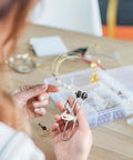 Person using Six Pack Stainless Steel Lever Action Grid Clamps Built to Last Rustproof Tile Mounting Grip for jewelry making.