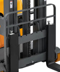 Full Electric Counterbalanced Stacker With A Solid 2200 Lb Lift Capability showing the straddle forks and chain lifting mechanism.