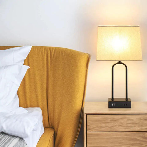 Must-Have Set Of 2 Modern Touch Lamps With Dual USB Ports And AC Outlet on a bedroom nightstand, cream shade glowing softly.