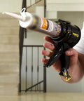 Man holding Tiny 4 Inch Caulking Gun No Drip With Patented Design Lightweight ABS Frame Two Pack Fits All 10 Oz Tubes