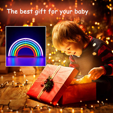 Child opening gift next to Rainbow Neon Light Sign For Bedroom LED Colorful Rainbow Wall Decor With USB Or Battery inset.