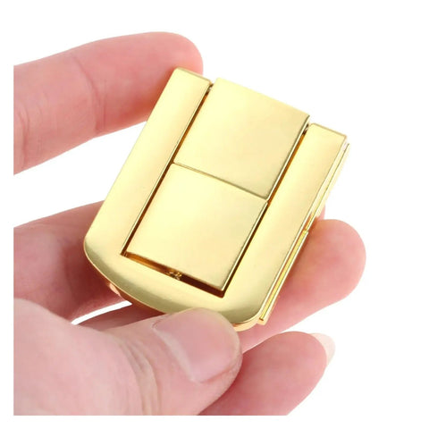 Close-up of gold heavy duty zinc alloy toggle catch lock hasp latch set for boxes, cabinets, drawers, 43mm by 22mm size in hand