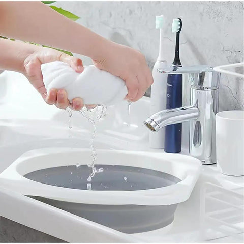 Person squeezing a towel over Road Trip Ready Lightweight Folding Wash Basin One Point Four Gallon Capacity No Fuss Bpa Free Plastic soaking tub.