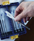 Hand holding a drill bit from the Speedbor Max 8-Piece Wood Drill Bit Set with Clear Lid, Stackable Case for Easy Viewing and Travel Ready