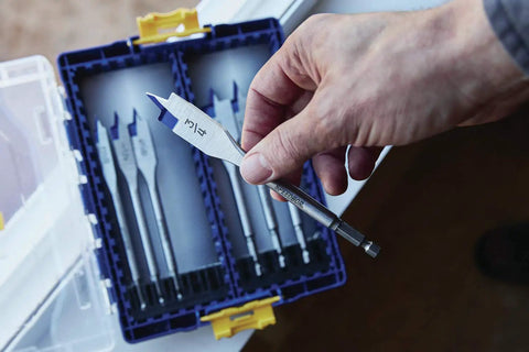 Hand holding a drill bit from the Speedbor Max 8-Piece Wood Drill Bit Set with Clear Lid, Stackable Case for Easy Viewing and Travel Ready