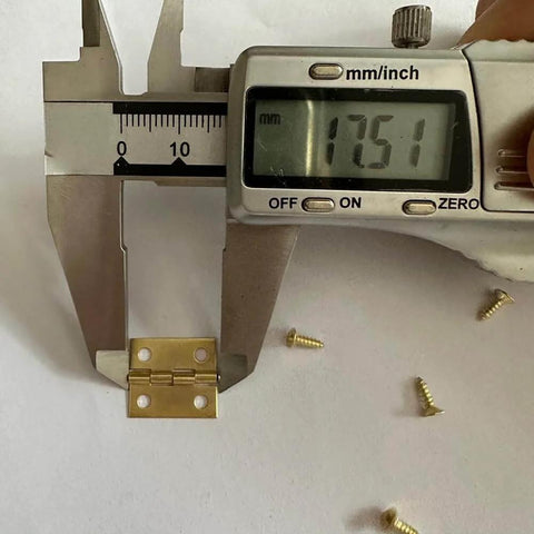 Close-up of 50 Pcs Small Metal Butt Hinges With 200 Screws For Crafts And DIY Projects 18x15mm alongside caliper measurement.