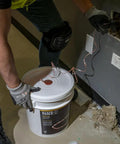 Person pulling Poly Pull Line For Wire Pulling, Orange Tracer Cord, Light Duty Cable String, 6500 Foot Length, from a wall outlet