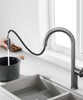 TXGJWRA Green Pull-Faucet with 360-Degree Swivel Spray Head, Single Hole Sink Mixer, Modern Kitchen Tap pouring water into a pot.