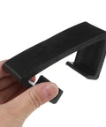 Close-up of a hand holding a black clip from 4 Pack Outdoor Furniture Clips For Wicker Sectional Sofas And Rattan Chairs Black 90mm Inner Diameter Easy Clip Fasteners For Seamless Sectional Alignment And No Fuss Outdoor Lounge Sets