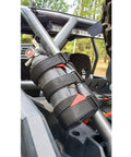 Universal UTV Roll Bar Fire Extinguisher Holder With Adjustable Velcro Straps Enhanced Stitching Quick Release Buckle Black Plated Hardware installed on roll bar, securing an extinguisher.