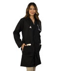Person wearing Unisex Lab Coat For Work, Long Sleeve Medical Coat With Five Pockets And Pen Slot, Durable Poly Cotton Doctor Uniform, Sharp Hospital And Clinic Look, 38 Inch Black XL.
