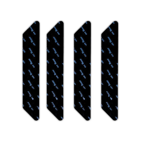 Image of four black strips showing the 12 Piece Reusable No Slip Rug Grippers For Secure Rug And Mat Placement Washable Carpet Tape.