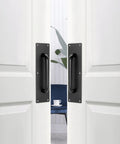 Stainless Steel Door Push Plates 4 Pack With Screws installed on double doors, black finish, suitable for home office or public spaces.