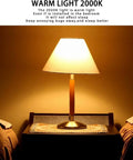 Bedside lamp with 2000K warm light glow in a bedroom setting, showcasing Amber Dusk To Dawn Outdoor Bug Light Bulbs 2 Pack Auto On Off.