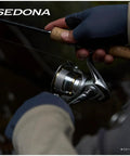 Close-up of a hand holding Sedona C5000XG Spinning Reel With 24.3 Lbs Max Drag And 13.3 Lbs Practical Drag, 11.2 oz for angling