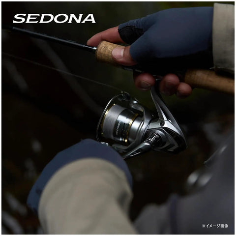 Close-up of a hand holding Sedona C5000XG Spinning Reel With 24.3 Lbs Max Drag And 13.3 Lbs Practical Drag, 11.2 oz for angling