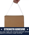 Clear Packing Tape Bulk Pack Of 36 Heavy Duty Rolls For Shipping And Moving Sealing used to lift a box, showing strength adhesive.