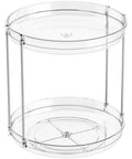 Totally Slick No Hassle 360 Spin Vanity Organizer Two Tier Clear Acrylic Rotating Storage for perfume and lotion on a desk.
