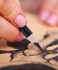 Close-up of a hand using a charcoal pencil for drawing on paper, Charcoal Pencils For Drawing Set 10 Pack Includes Black White Brown Suntan Assorted