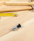 Stainless Steel Reset Indexing Plunger With Knob And Self Locking Mechanism M10 on a wooden surface with tools.