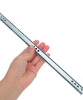 Hand holding Four Pack Drawer Slides Twelve Point Two Inch Side Mount With 17mm Groove Dual Directional Ball Bearing Rails