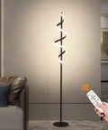 Tall Black Spiral Torchiere Floor Lamp With Remote Dimming And Color Changing LED, 63 Inch Tall, next to a sofa in living room.