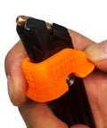 Close-up of Mini Magazine Speed Loader Fits Ruger Mark I II III IV 22 45 And Browning Buck Mark 22LR in hand, orange grip.