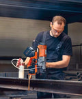 Heavy Hitter Portable Magnetic Base Drill Machine With Brushless Motor 18V Cordless Power Tool in action on structural steel.