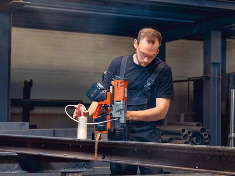 Heavy Hitter Portable Magnetic Base Drill Machine With Brushless Motor 18V Cordless Power Tool in action on structural steel.