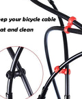 Close-up of black bike cables with red clips from Mechanical Bike Disc Brake Kit With Front And Rear Calipers 160mm Rotors Cables Levers Rotor Adjuster End Caps Rotating S Hook Clips And Red Finish All In One Braking Upgrade For Easy Install.
