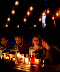 Shatterproof LED Outdoor String Lights 48Ft IP65 Waterproof Edison Vintage lights illuminating a group dining outdoors.
