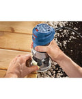 Person using Colt 1.25 HP Variable Speed Palm Router With 7 Amp Motor Precision Handheld Router for routing wooden surface