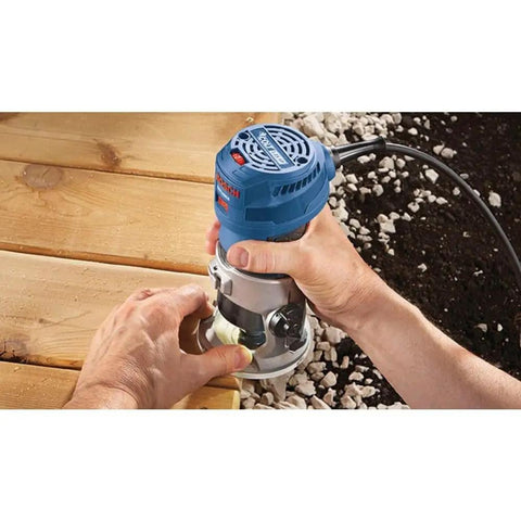 Person using Colt 1.25 HP Variable Speed Palm Router With 7 Amp Motor Precision Handheld Router for routing wooden surface