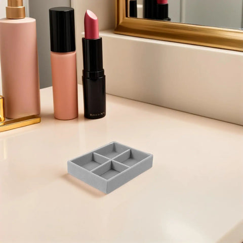 Velvet Jewelry Organizer Tray With Four Grid Compartments Stackable Minimalist design on tabletop beside cosmetics.