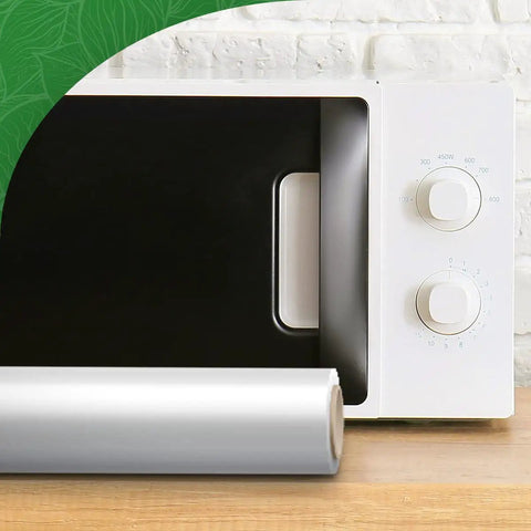 Roll of pro grade vacuum sealer wrap in front of a microwave, highlighting BPA free commercial grade material for sous vide cooking.