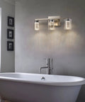 Three Light Brushed Nickel Vanity Light Fixture With Crystal Glass Shades Dimmable LED Bath Vanity Sconce in a bathroom