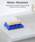Soap on a blue rippled soap holder on a white sink, highlighting water resistance in wet conditions.