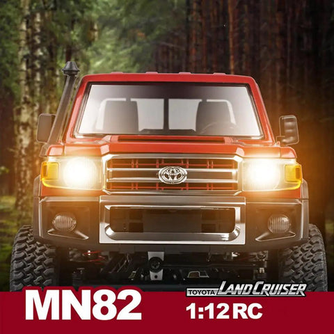 Front view of RC Beast Rock Crawler Truck 4x4 Toyota LC79 One Twelfth Scale Off Road Pickup with headlights on in forest setting.